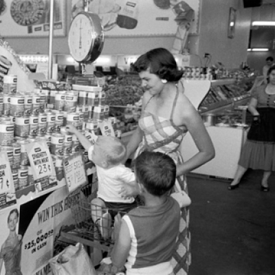 A family shops at a grocery store in El Dorado, AR in 1955